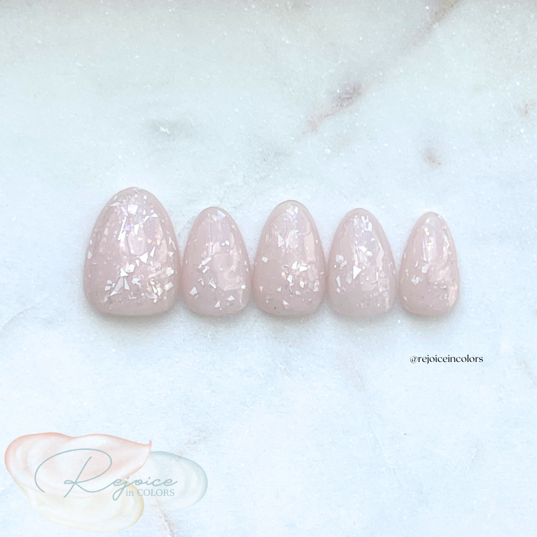 Nude base with broken flakes nail set on a tile